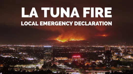 LA TUNA FIRE LOCAL EMERGENCY DECLARATION. IMAGE OF BURNING HILLSIDE AT NIGHT
