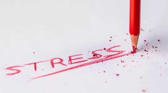 The word, &quot;stress&quot; written on a piece of paper.