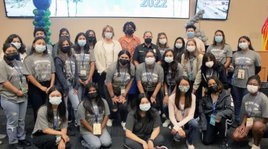 Young women campers shown at recent HERricane (spelled H-E-R) event in Los Angeles pose with FEMA Administrator, one of the main speakers.