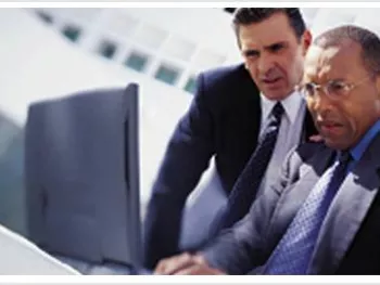 Two businessmen using laptop