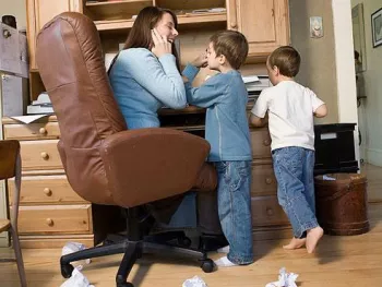Children with mother in home office