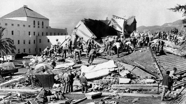 Crews asses a structurally demolished building due to the Sylmar earthquake in 1971