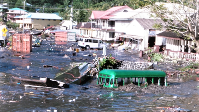 Photo of the damage done by a tsunami shows cars helf-submerged and building flooded.